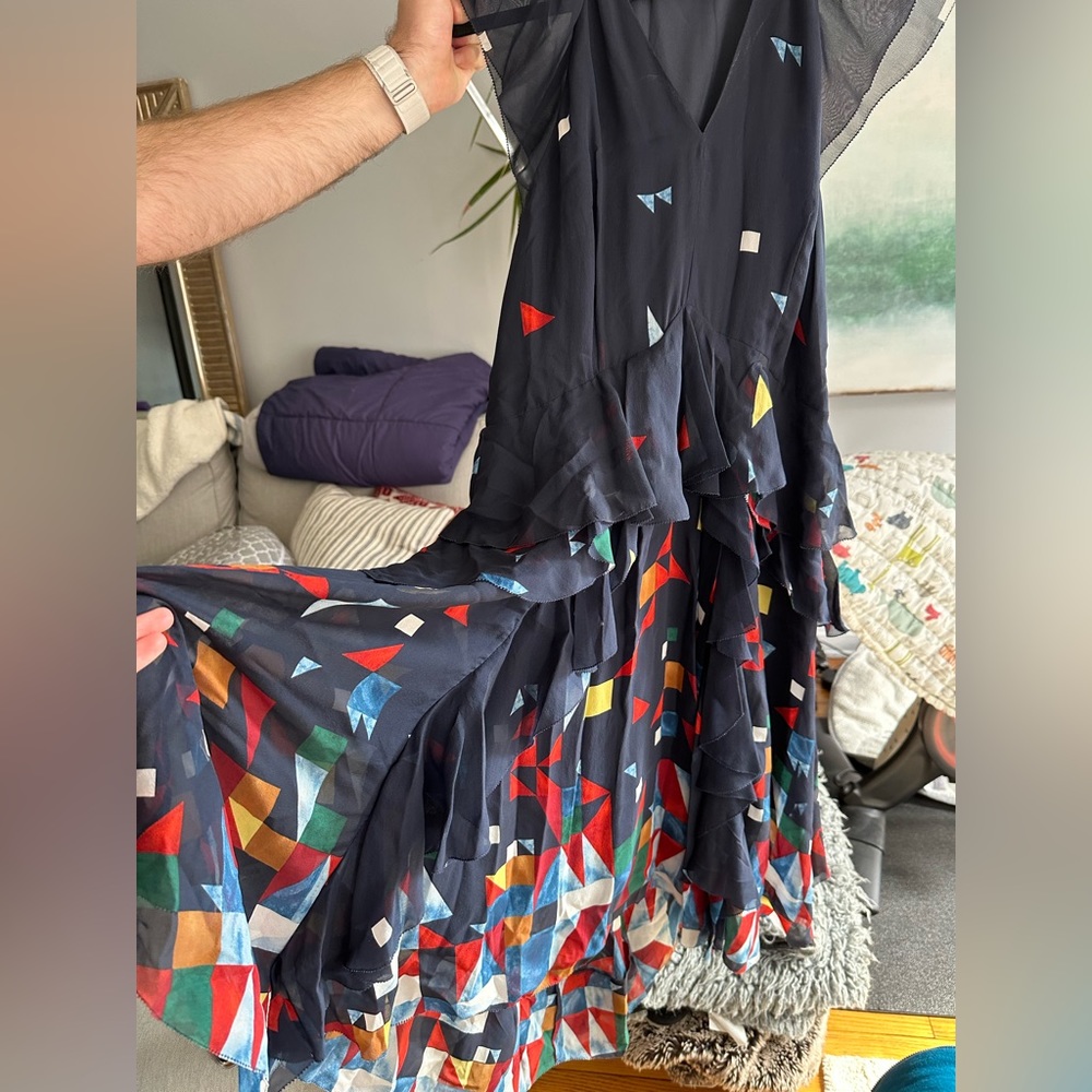 Flowing Joie dress with geometric print. Sheer cap sleeves and pleated skirt.